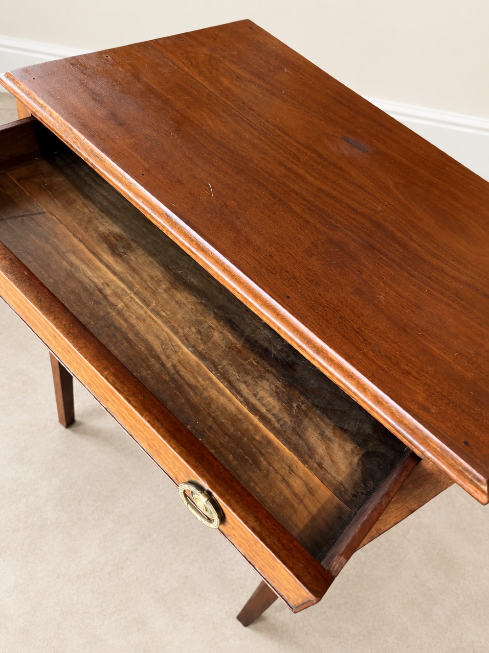 A 19th-century mahogany side table featuring a single drawer with twin brass ring drop handles and straight legs joined by low stretchers. View V