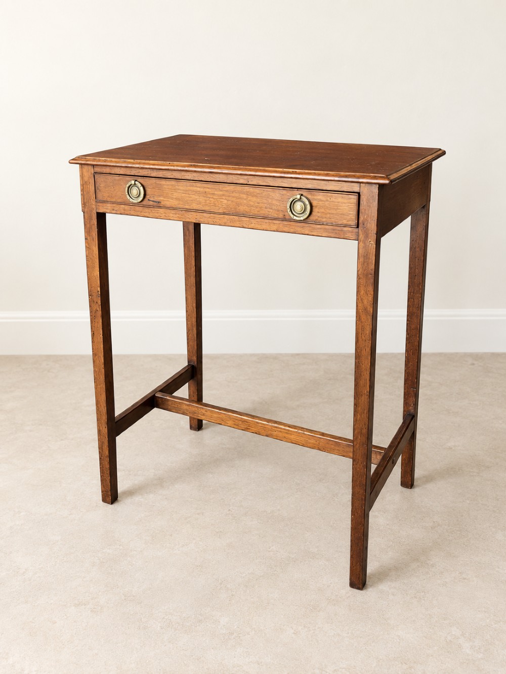 A 19th-century mahogany side table featuring a single drawer with twin brass ring drop handles and straight legs joined by low stretchers. View VI