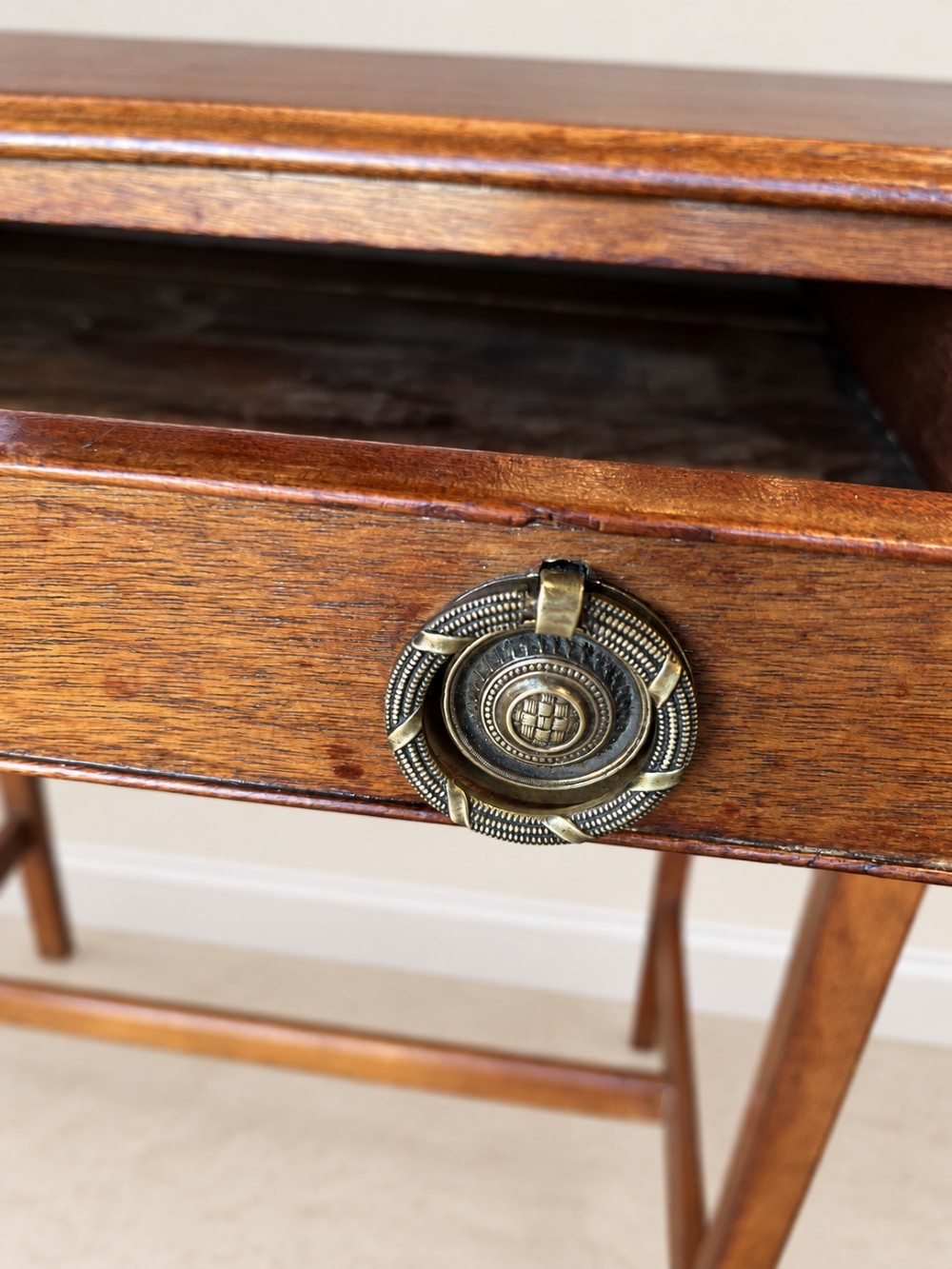 A 19th-century mahogany side table featuring a single drawer with twin brass ring drop handles and straight legs joined by low stretchers. View VII