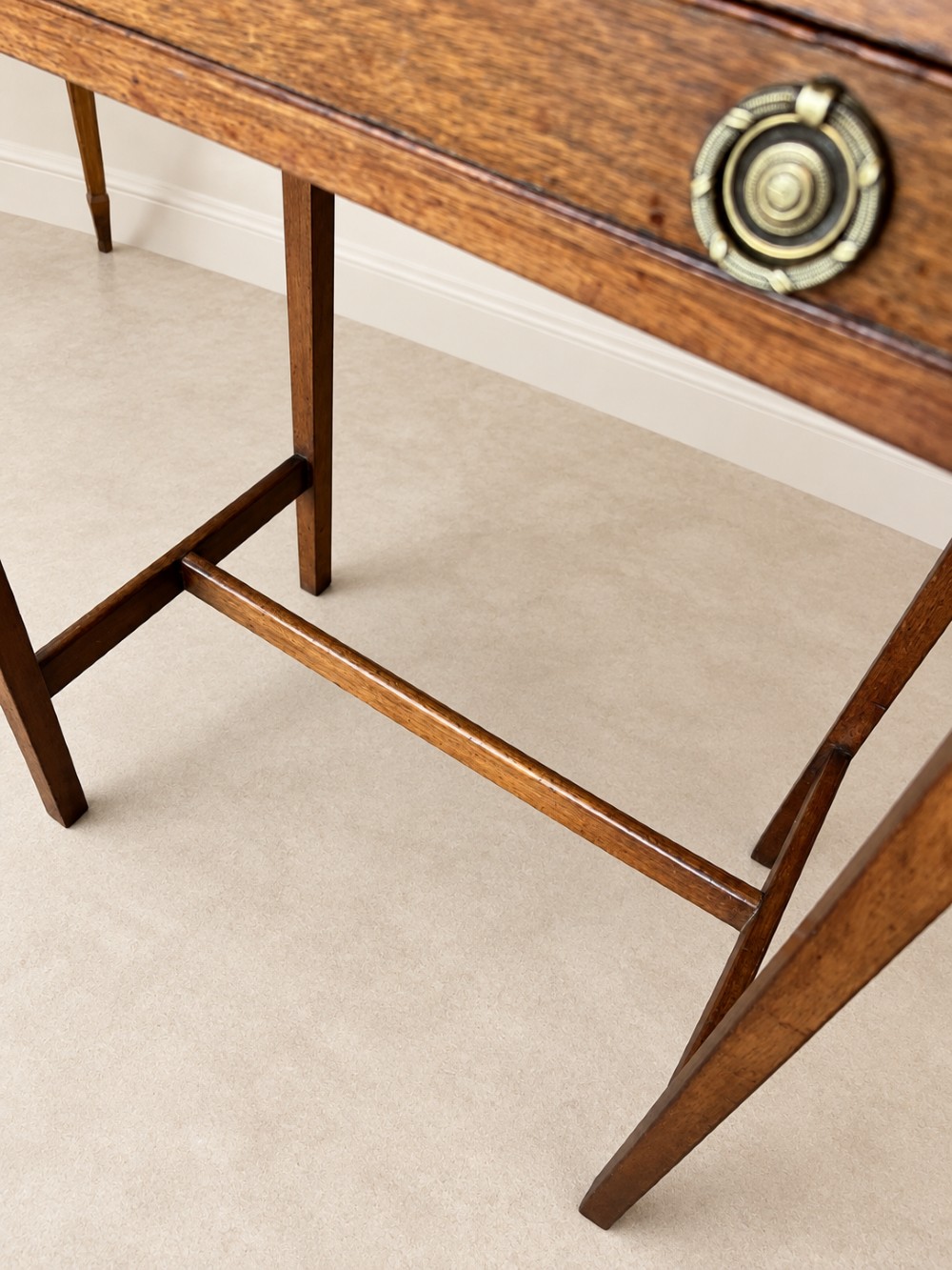 A 19th-century mahogany side table featuring a single drawer with twin brass ring drop handles and straight legs joined by low stretchers. View IX