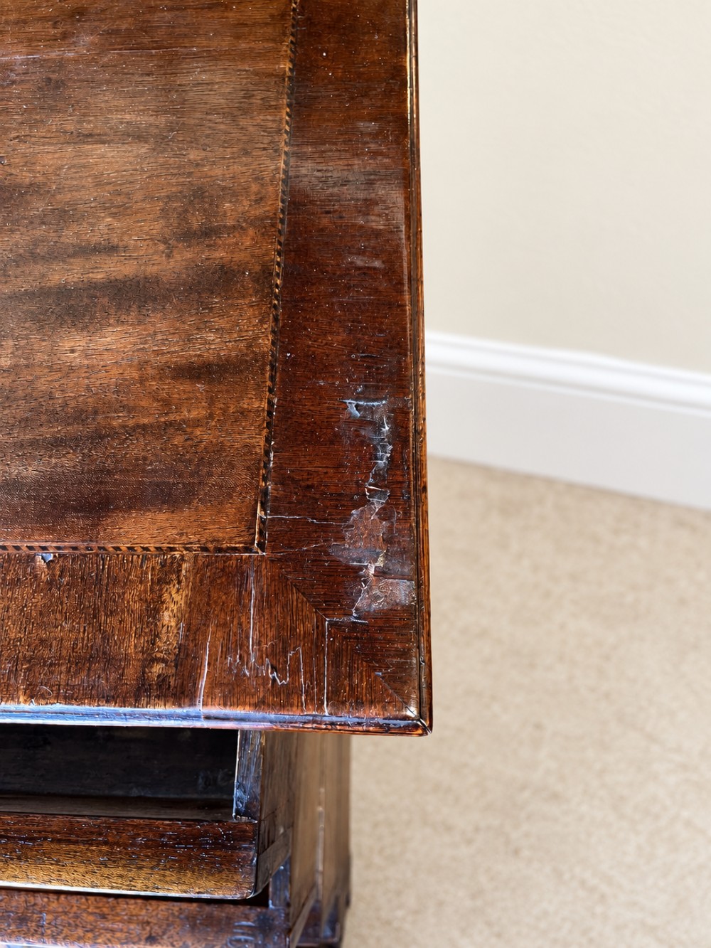 An antique George III mahogany chest of drawers featuring two short over three long drawers with decorative brass swan-neck handles and bracket feet. View VIII