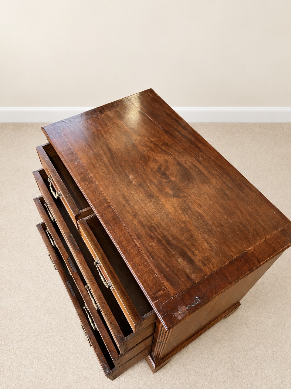 An antique George III mahogany chest of drawers featuring two short over three long drawers with decorative brass swan-neck handles and bracket feet. View IX