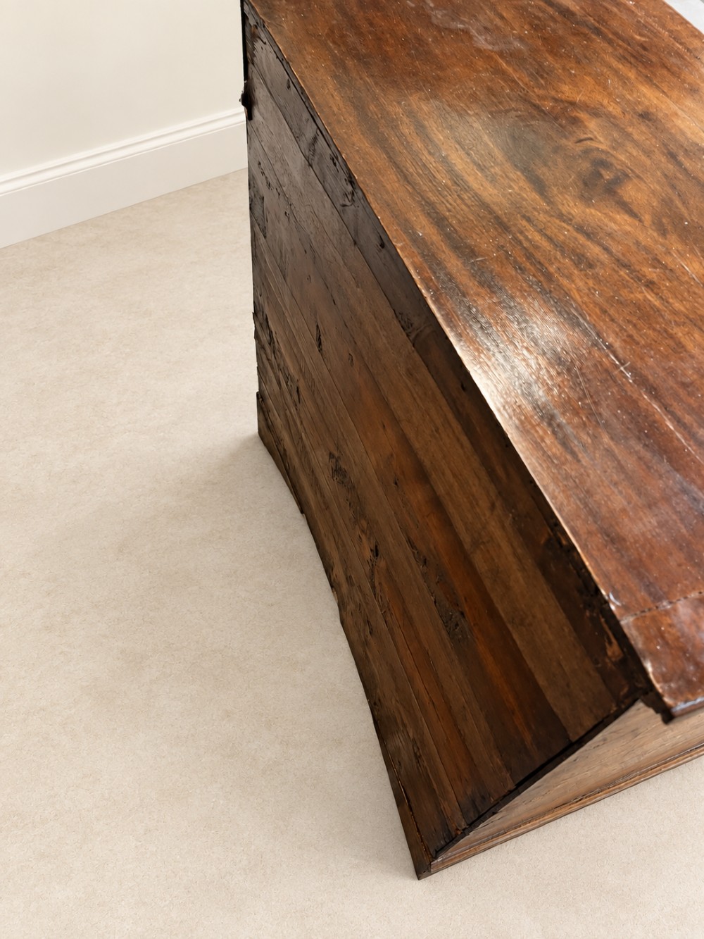 An antique George III mahogany chest of drawers featuring two short over three long drawers with decorative brass swan-neck handles and bracket feet. View XII