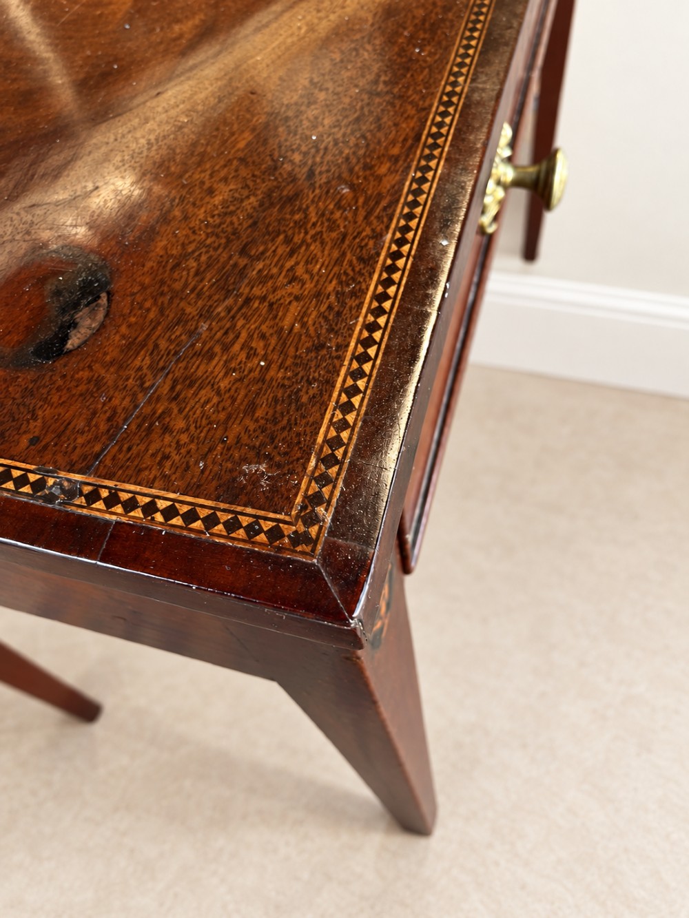 An antique nineteenth-century mahogany side table featuring a single drawer, brass handles, decorative oval floral inlay, and slender tapered legs. View IX