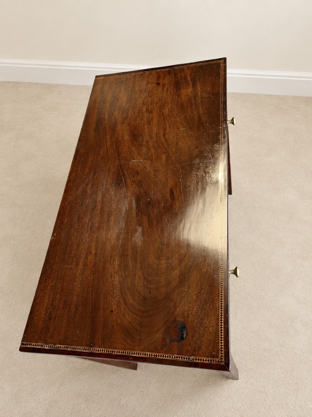 An antique nineteenth-century mahogany side table featuring a single drawer, brass handles, decorative oval floral inlay, and slender tapered legs. View X