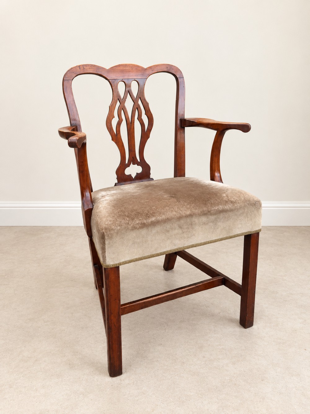 A Georgian yew wood armchair featuring a pierced back splat, curved arms, square legs with stretchers, and a neutral velvet upholstered seat. View III