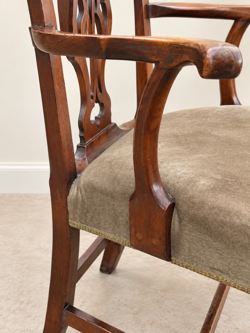 A Georgian yew wood armchair featuring a pierced back splat, curved arms, square legs with stretchers, and a neutral velvet upholstered seat. View IV
