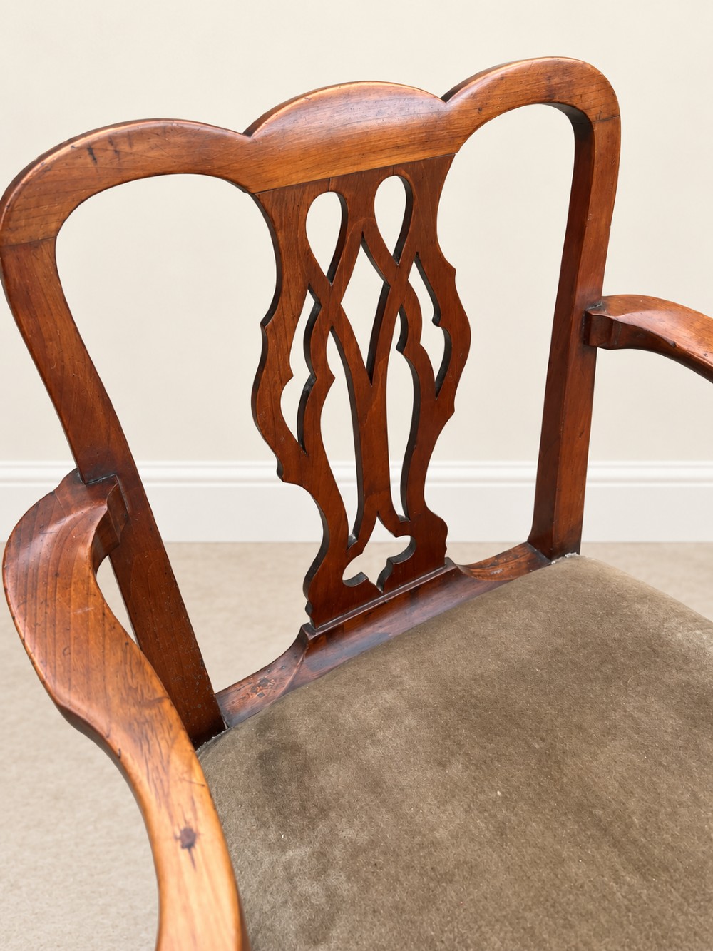 A Georgian yew wood armchair featuring a pierced back splat, curved arms, square legs with stretchers, and a neutral velvet upholstered seat. View V