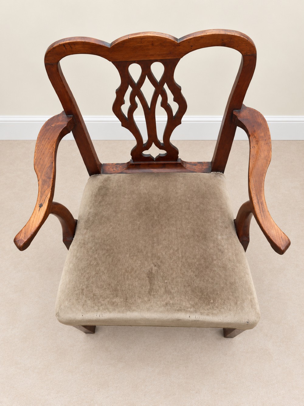 A Georgian yew wood armchair featuring a pierced back splat, curved arms, square legs with stretchers, and a neutral velvet upholstered seat. View X