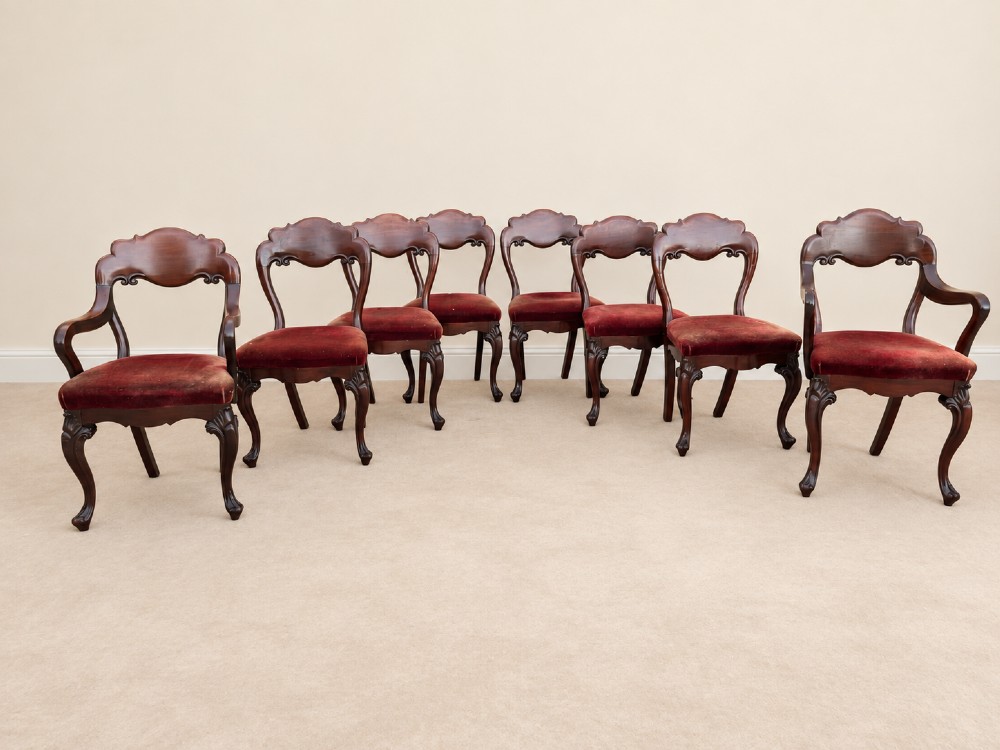 A set of eight 19th-century Victorian mahogany balloon back chairs with red velvet upholstery, including six side chairs and two carver armchairs with cabriole front legs. View II