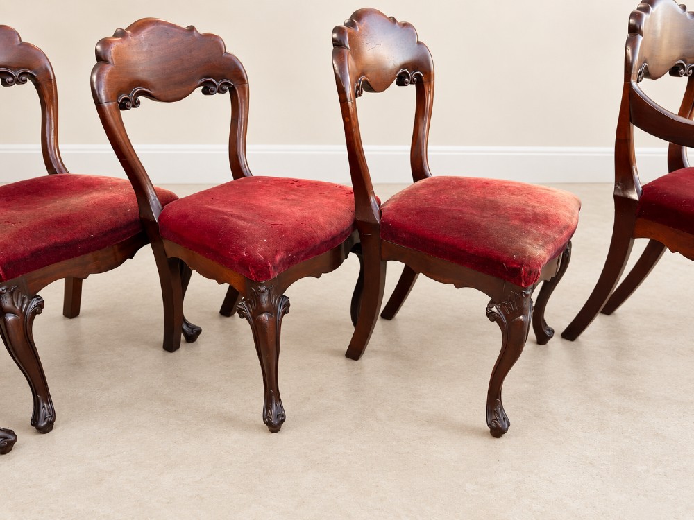 A set of eight 19th-century Victorian mahogany balloon back chairs with red velvet upholstery, including six side chairs and two carver armchairs with cabriole front legs. View V