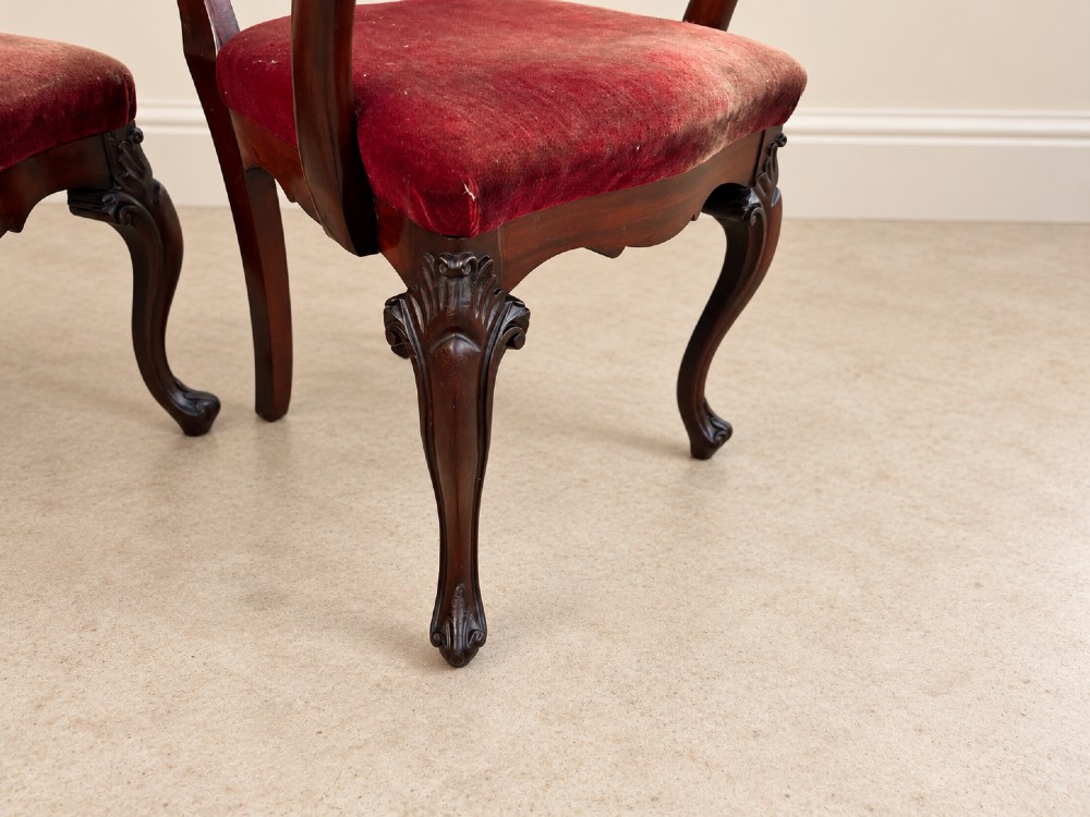 A set of eight 19th-century Victorian mahogany balloon back chairs with red velvet upholstery, including six side chairs and two carver armchairs with cabriole front legs. View VI