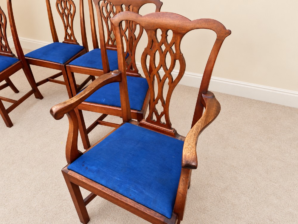 A set of six mahogany Chippendale style dining chairs comprising two carver armchairs and four side chairs with pierced fretwork backs and blue fabric drop-in seats. View III