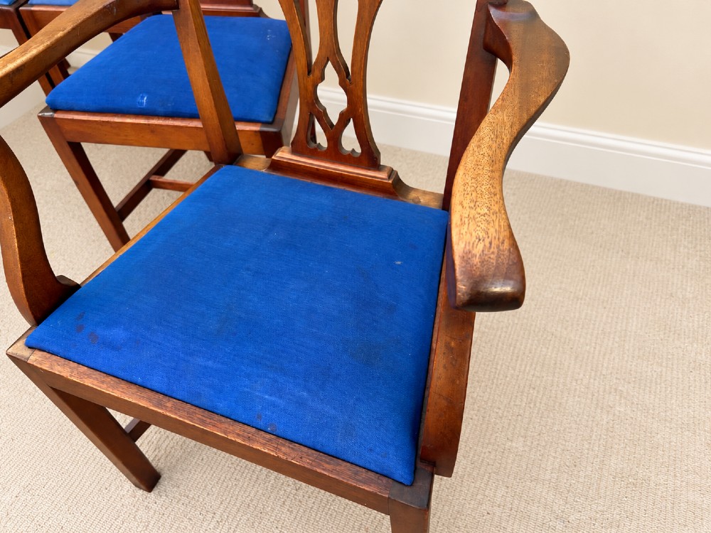 A set of six mahogany Chippendale style dining chairs comprising two carver armchairs and four side chairs with pierced fretwork backs and blue fabric drop-in seats. View IV