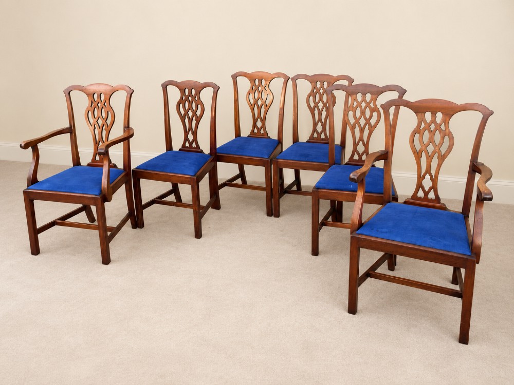 A set of six mahogany Chippendale style dining chairs comprising two carver armchairs and four side chairs with pierced fretwork backs and blue fabric drop-in seats. View VII