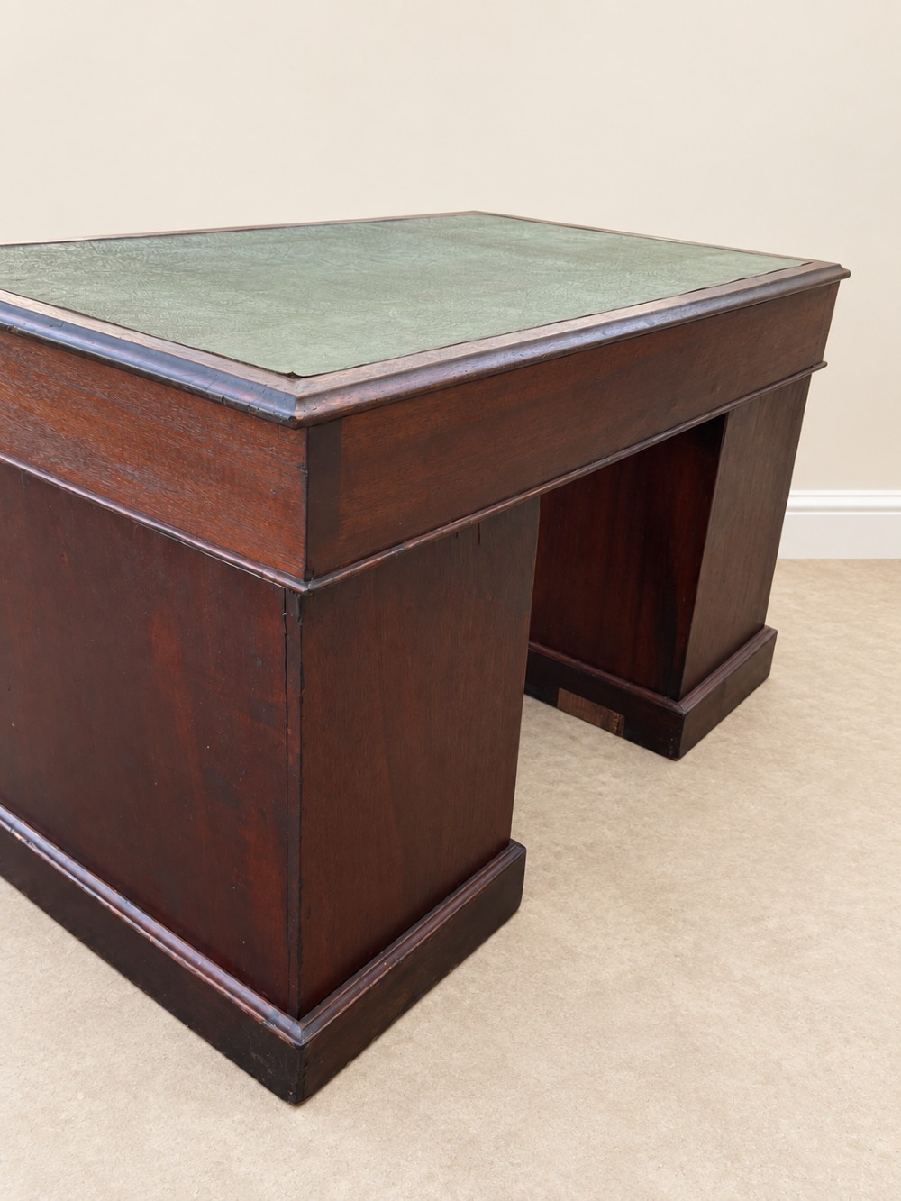 A 19th-century dark mahogany pedestal desk featuring nine drawers with brass handles and an inset green leather writing surface. View VIII