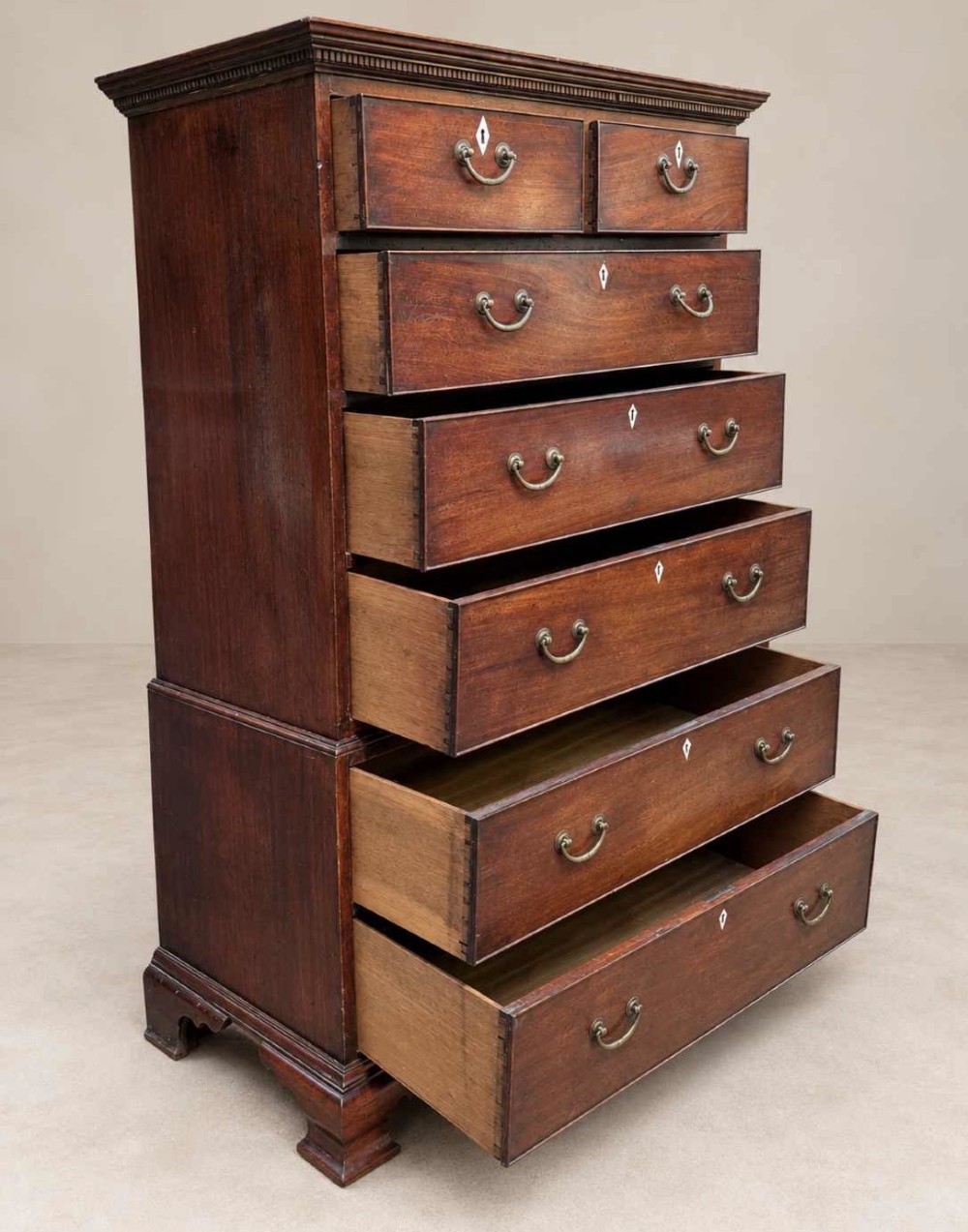 A tall Georgian mahogany chest on chest featuring brass swan-neck handles, diamond keyhole escutcheons, and ogee bracket feet. View III