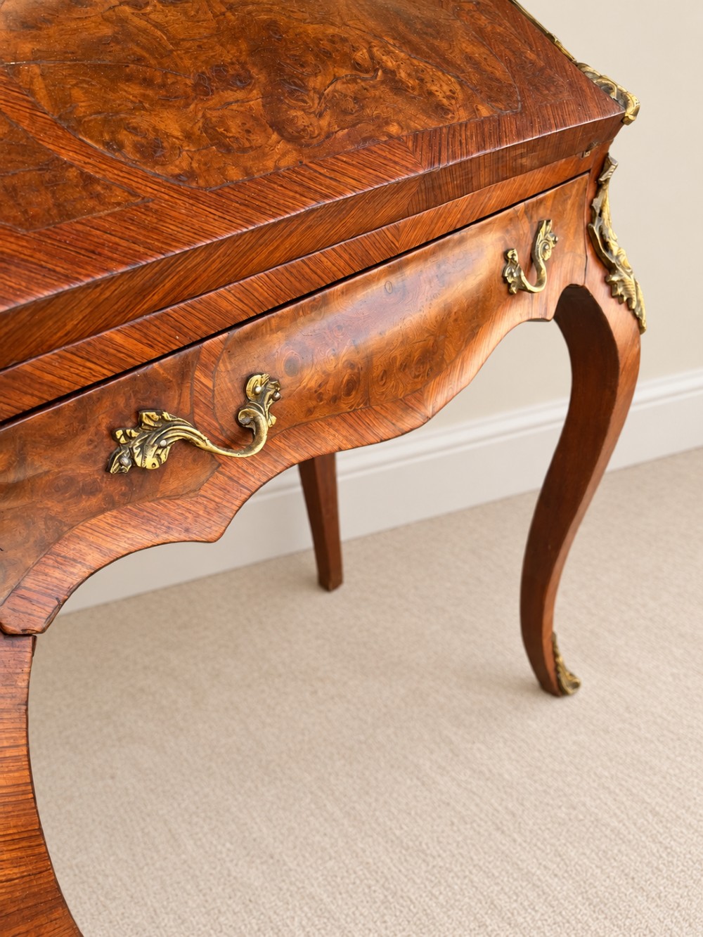 A 19th-century French Louis XV style walnut slant-front writing bureau featuring marquetry veneer, ornate gilt-bronze mounts, a brass pierced gallery, and long cabriole legs. View VII