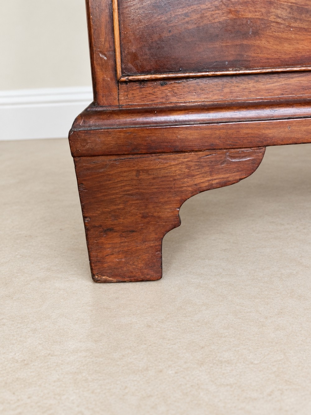 A Georgian mahogany bachelors chest featuring a brushing slide, two short over two long drawers, brass swan-neck handles, and bracket feet. View VIII