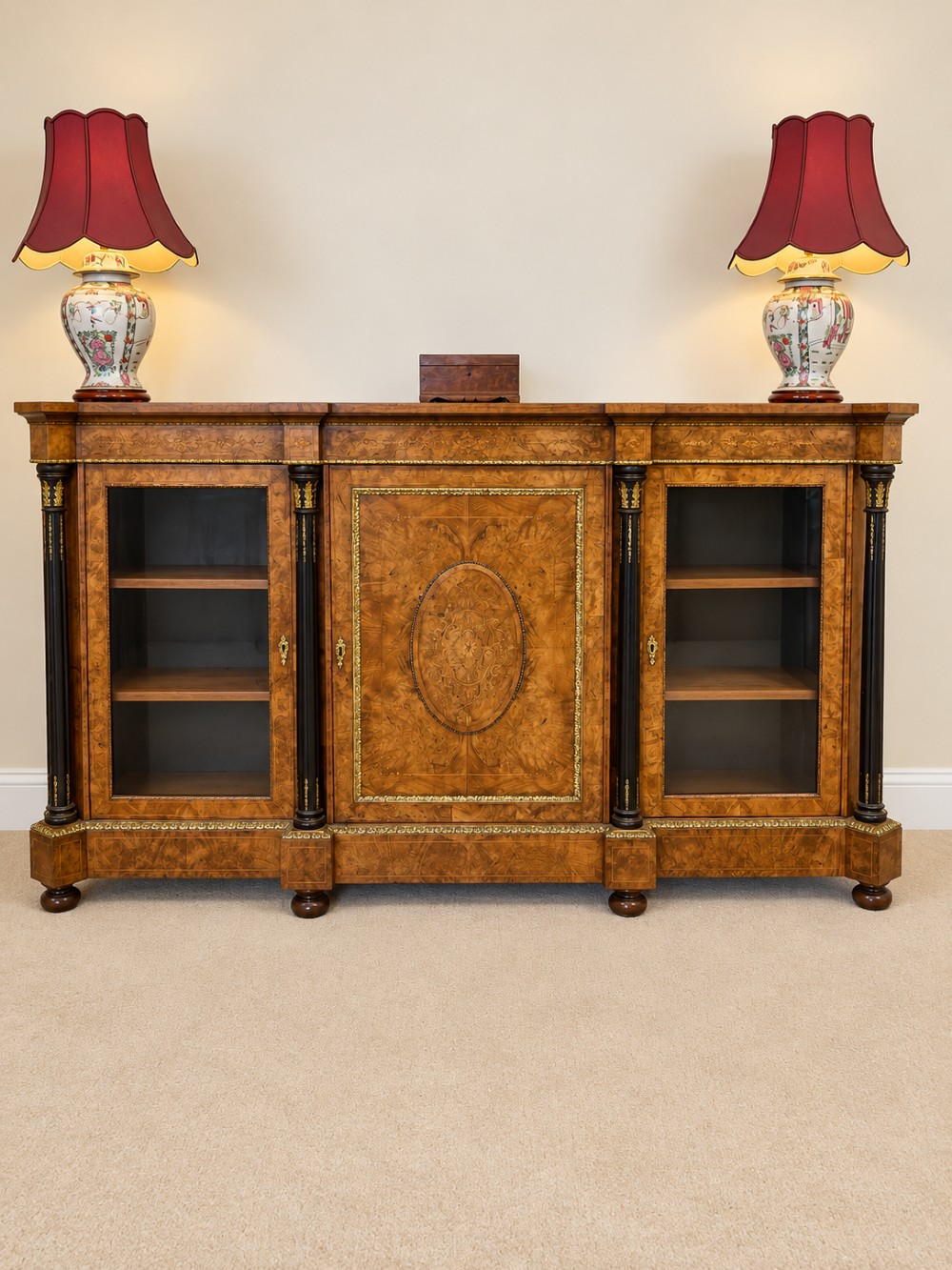 A 19th-century burr walnut credenza with a central marquetry-inlaid door flanked by two glass-front display cabinets and ebonised columns with gilt metal mounts. View XIII
