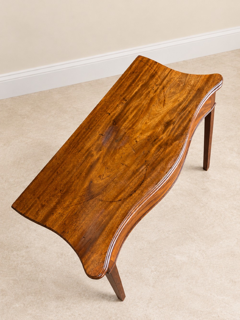 An antique Georgian dark mahogany fold-over table featuring a serpentine-curved front apron and four straight legs. View V