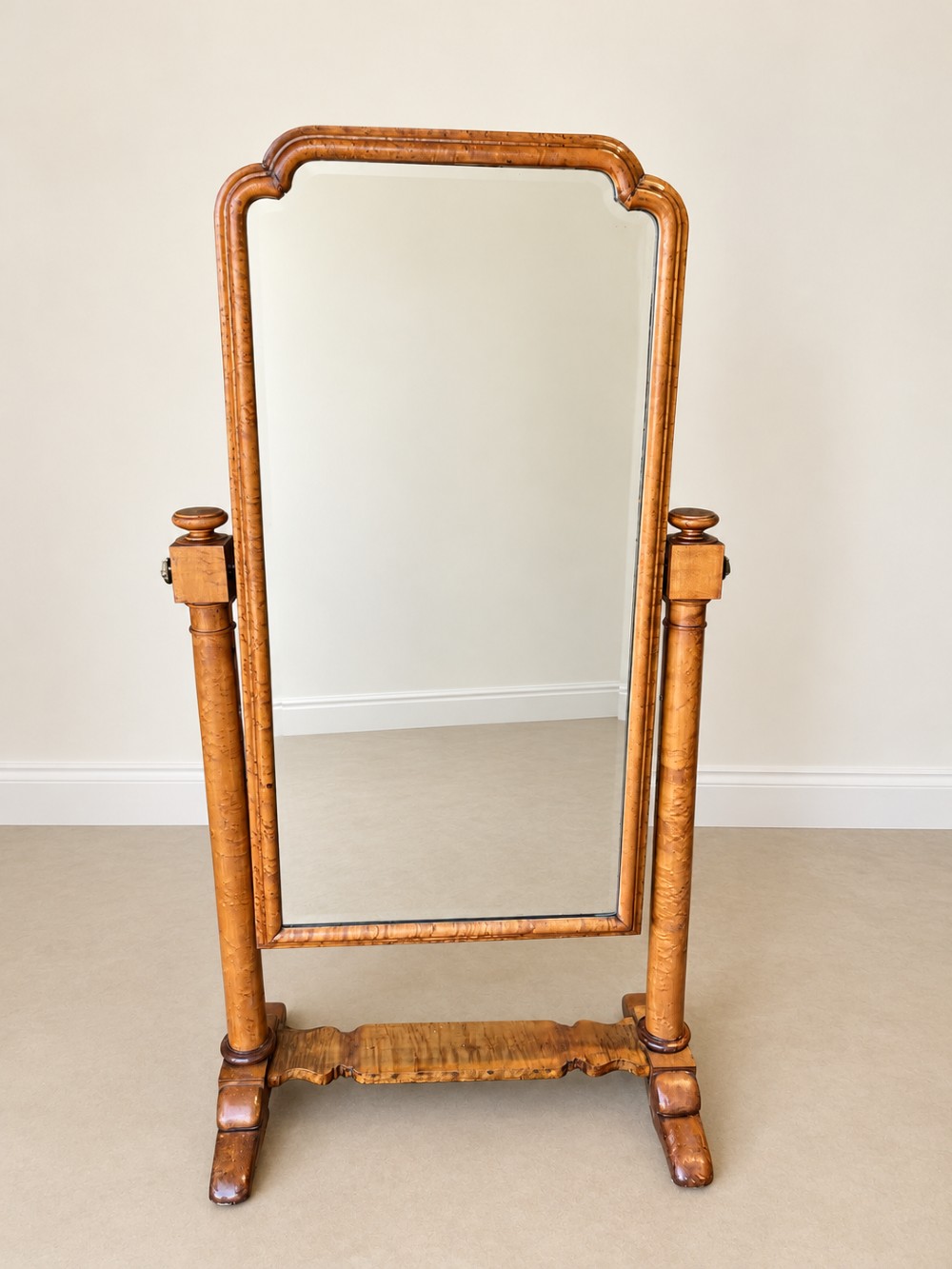 A 19th-century full-length satin birch cheval mirror featuring an arched top frame supported by turned upright pillars on splayed legs. View II