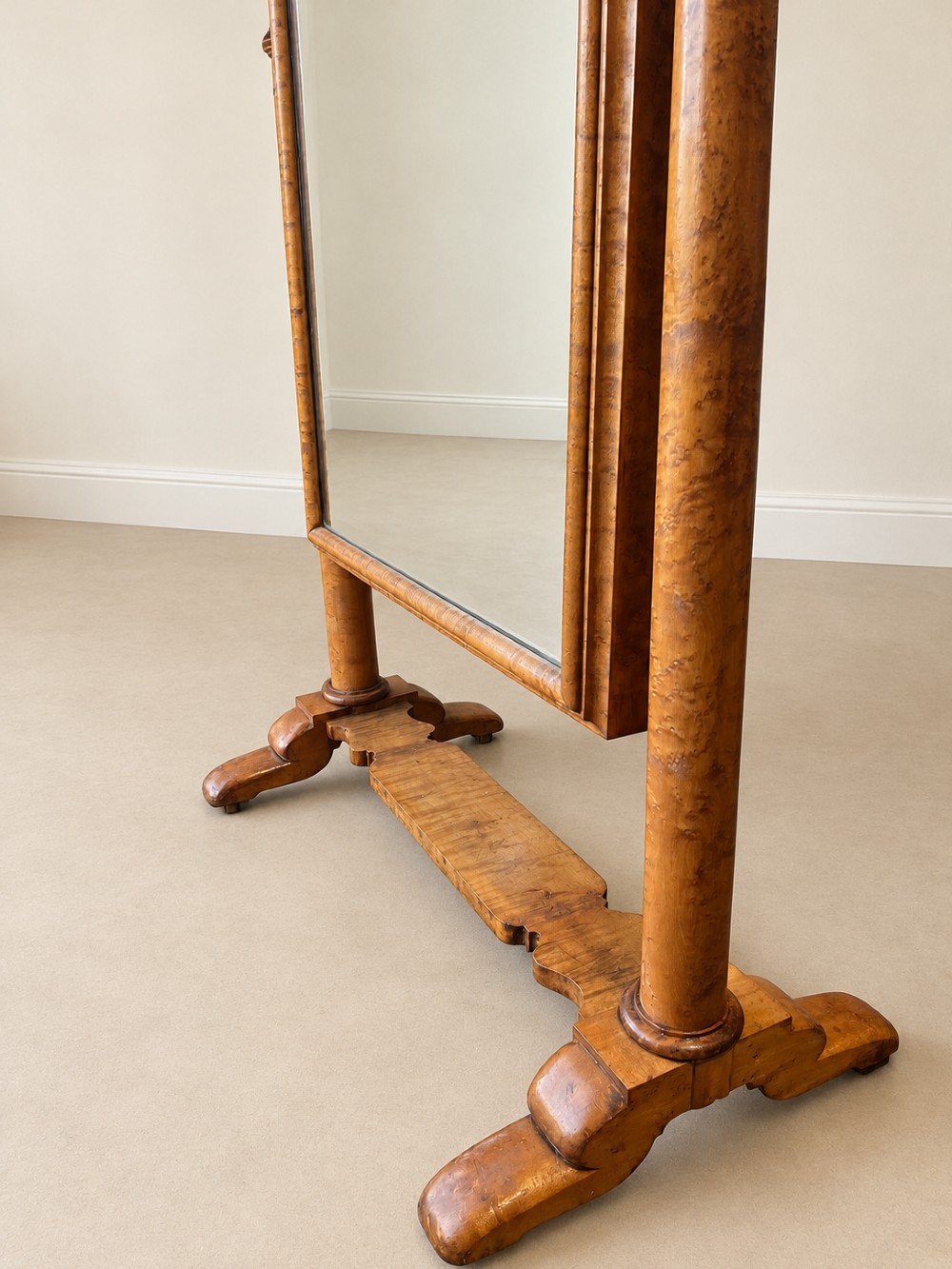 A 19th-century full-length satin birch cheval mirror featuring an arched top frame supported by turned upright pillars on splayed legs. View V