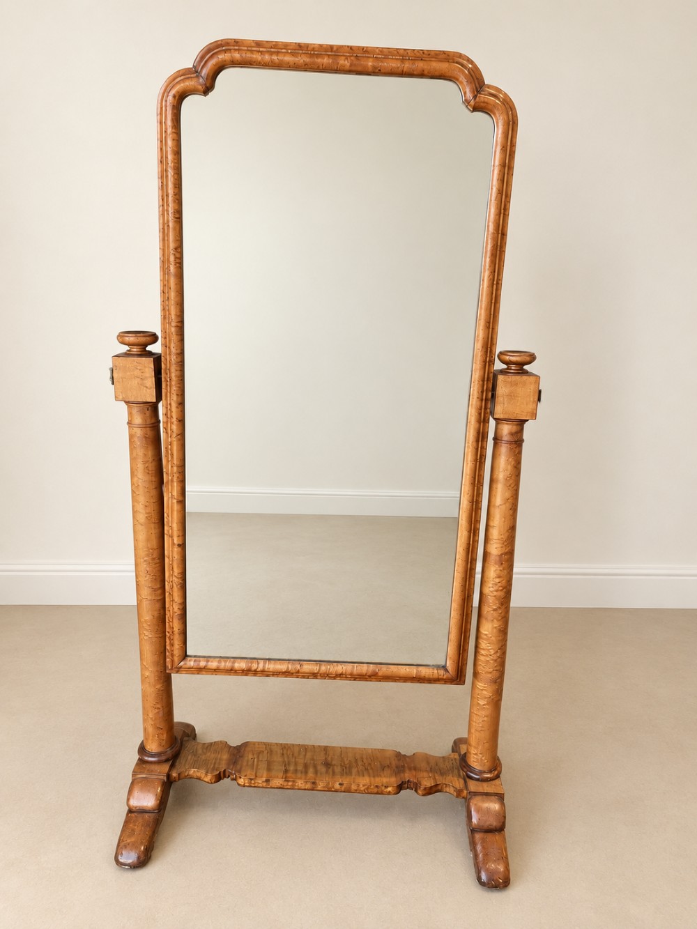 A 19th-century full-length satin birch cheval mirror featuring an arched top frame supported by turned upright pillars on splayed legs. View VI
