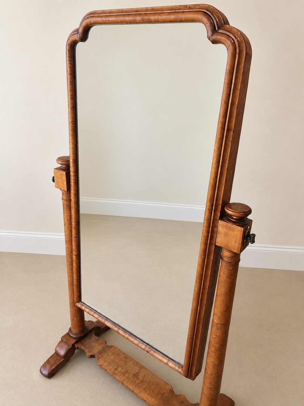 A 19th-century full-length satin birch cheval mirror featuring an arched top frame supported by turned upright pillars on splayed legs. View VII