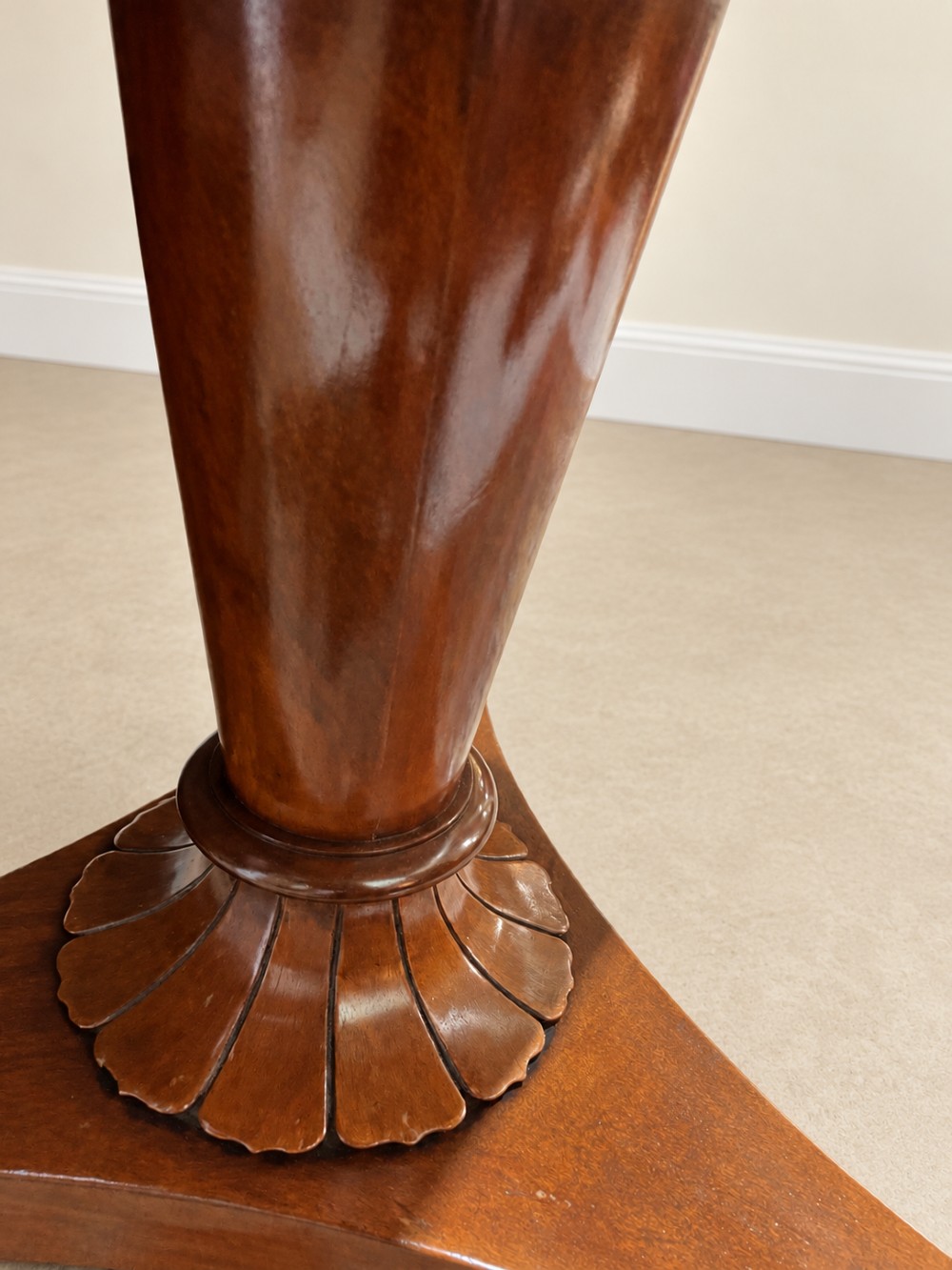 A 19th-century circular mahogany dining table featuring a polished top, turned central column with gadrooned base, and a tri-form platform resting on carved claw feet. View VIII