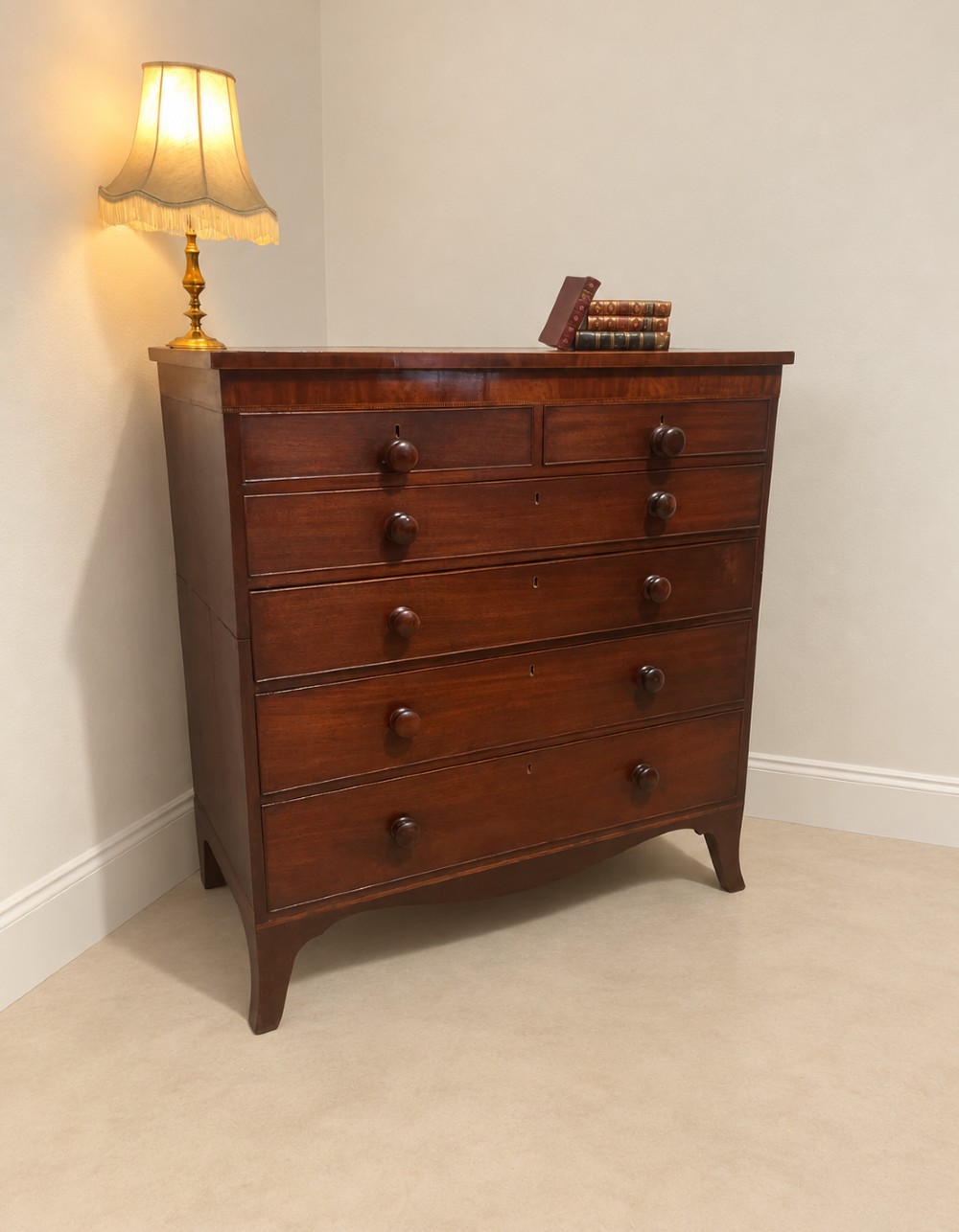 A 19th-century inlaid mahogany chest featuring two short drawers over three long drawers with turned knobs and splayed bracket feet. View II