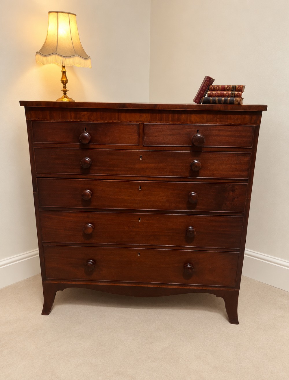 A 19th-century inlaid mahogany chest featuring two short drawers over three long drawers with turned knobs and splayed bracket feet. View IV