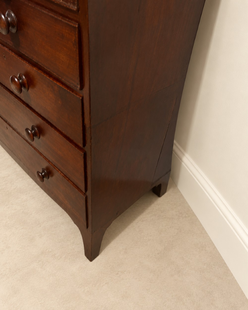 A 19th-century inlaid mahogany chest featuring two short drawers over three long drawers with turned knobs and splayed bracket feet. View V