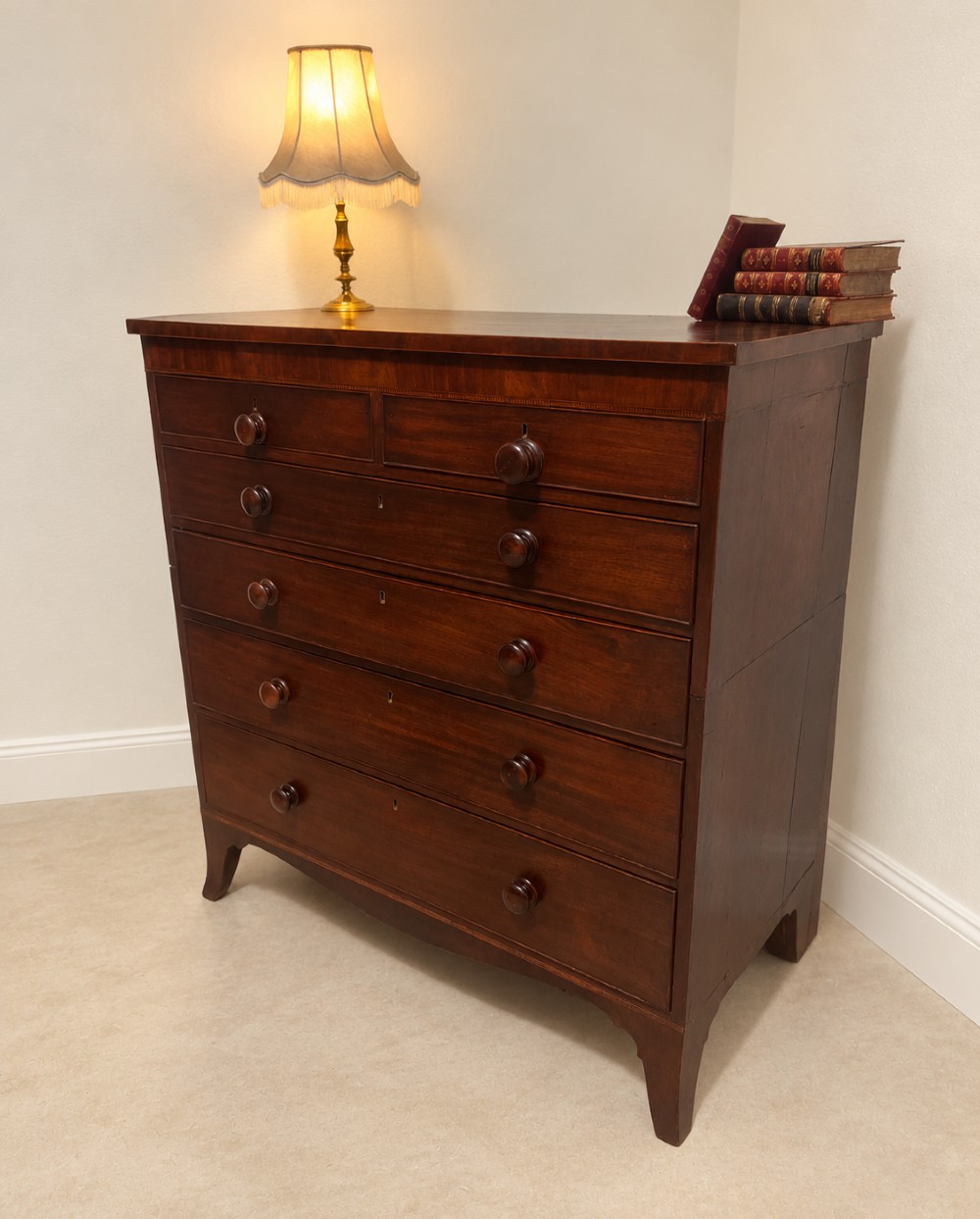A 19th-century inlaid mahogany chest featuring two short drawers over three long drawers with turned knobs and splayed bracket feet. View VIII