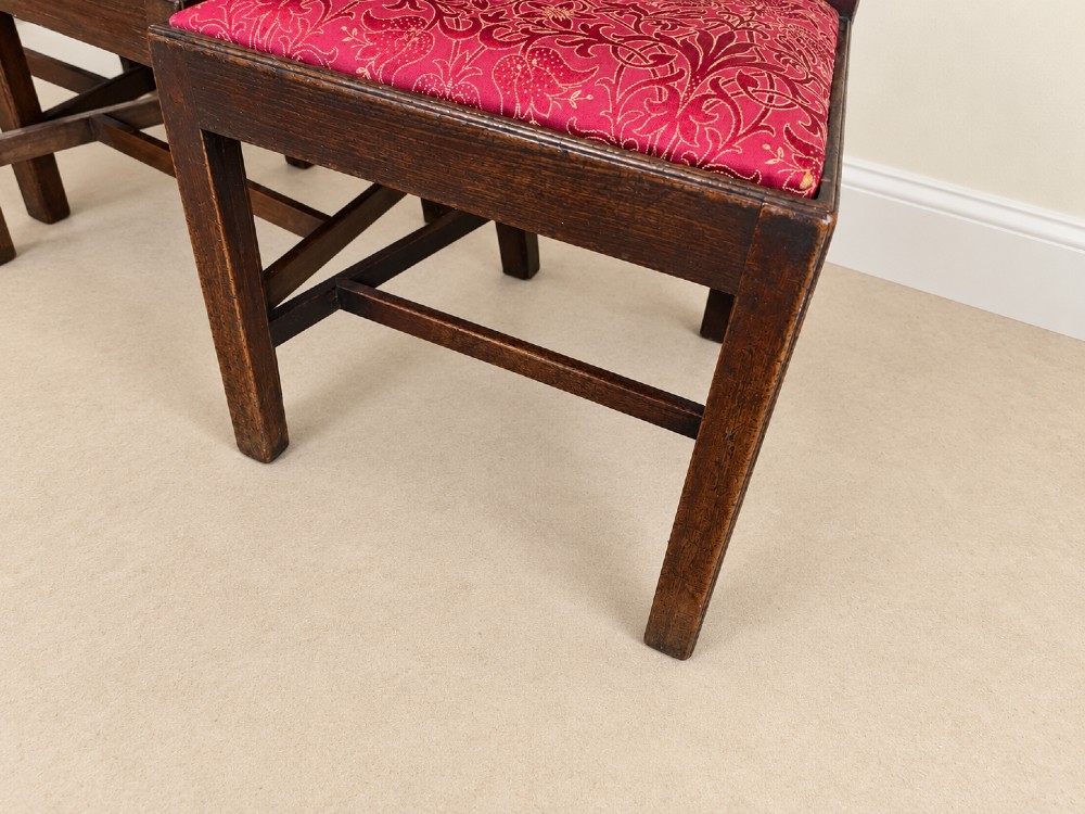 A set of six dark mahogany Georgian dining chairs featuring intricately pierced back splats and red patterned fabric drop-in seats. View IV
