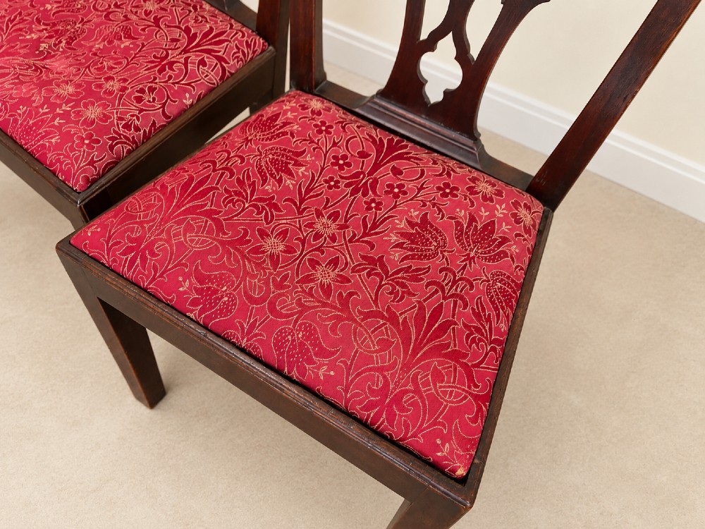 A set of six dark mahogany Georgian dining chairs featuring intricately pierced back splats and red patterned fabric drop-in seats. View VIII