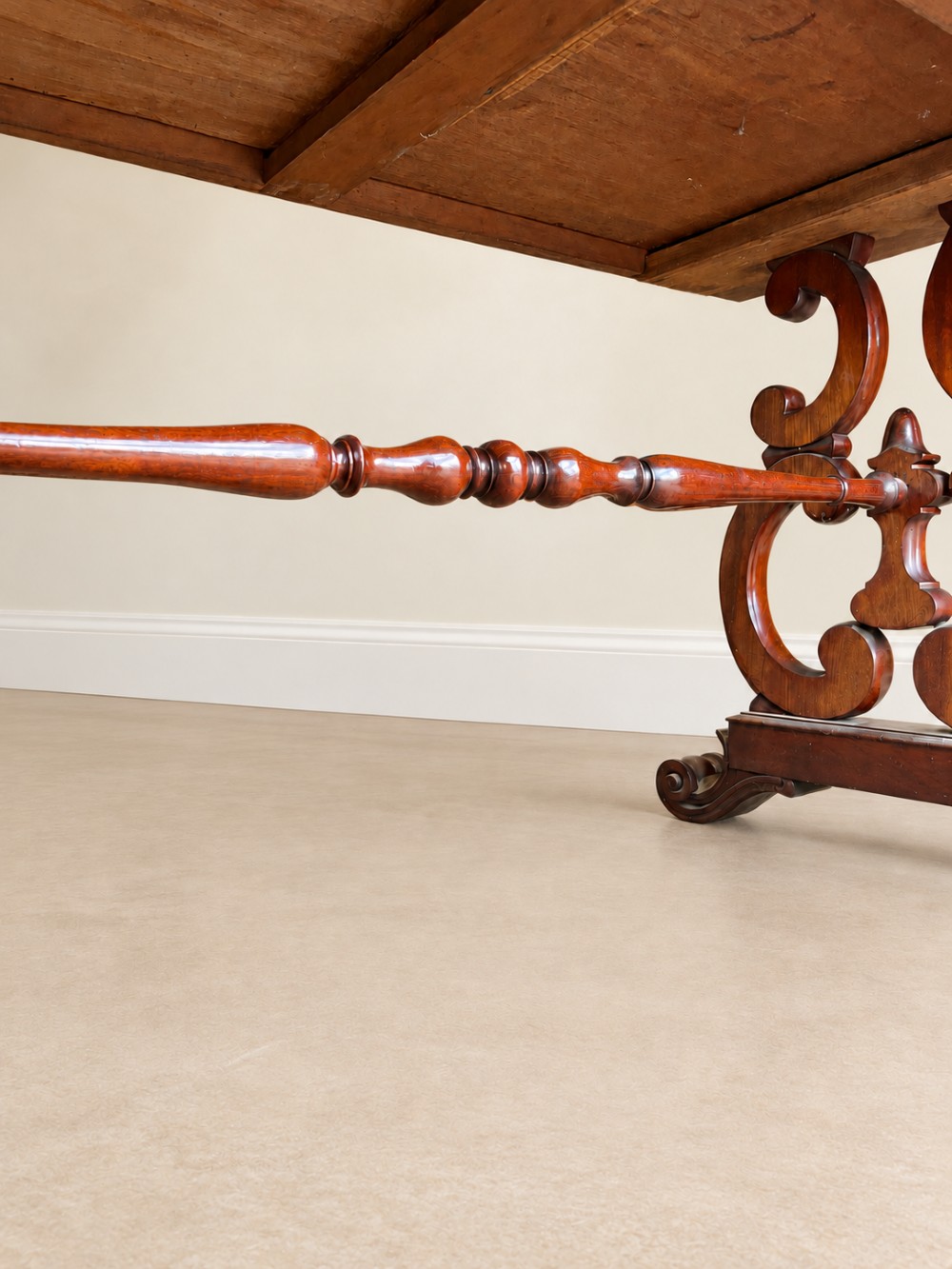 A 19th-century mahogany writing desk with a low gallery back, two frieze drawers, carved scroll trestle legs, and a turned stretcher. View X