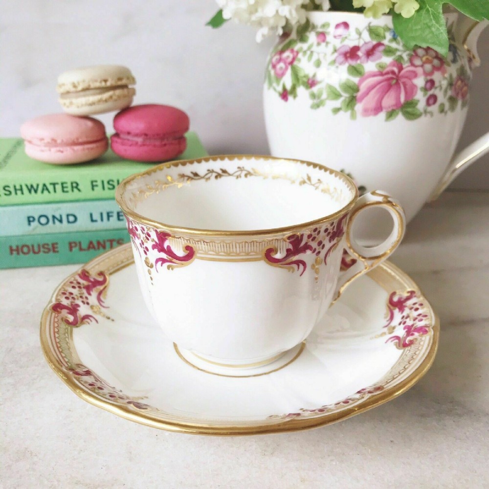 Antique Minton teacup and saucer duo, magenta pink and gold decoration