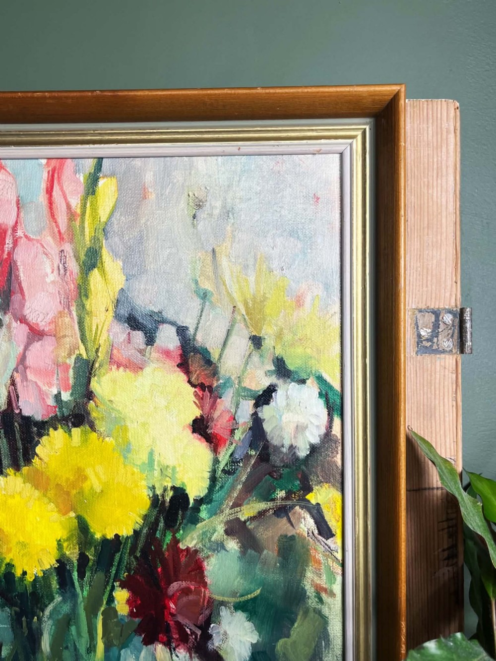 A framed mid-century oil on board painting featuring a colourful floral still life composition with yellow, pink, and green tones set within a wooden frame. View VIII