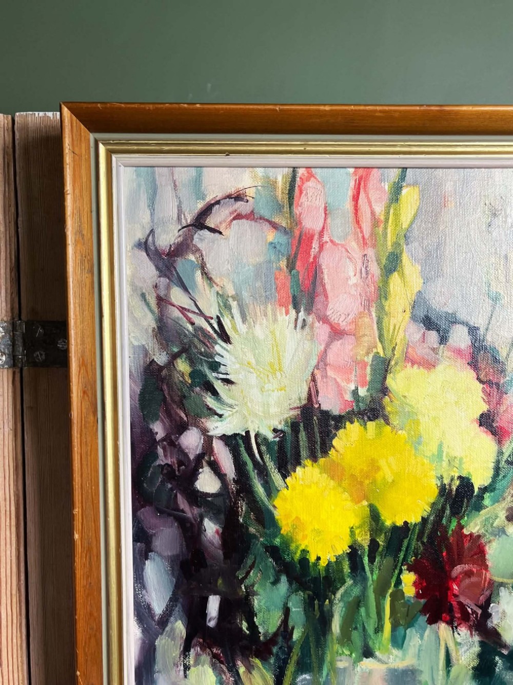 A framed mid-century oil on board painting featuring a colourful floral still life composition with yellow, pink, and green tones set within a wooden frame. View XIV