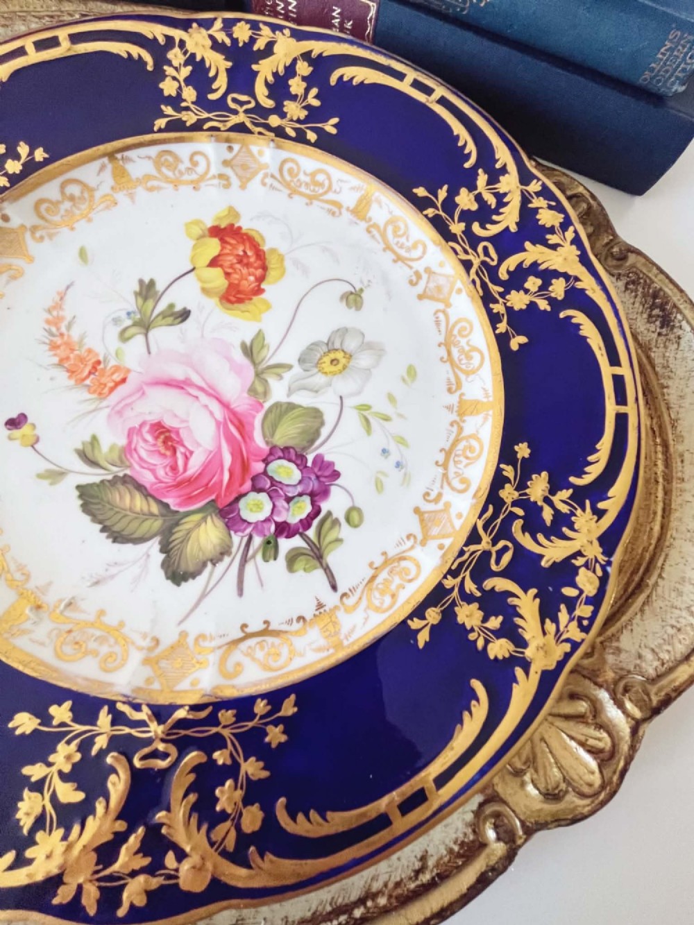 An antique Coalport porcelain dessert plate featuring a central hand-painted floral bouquet surrounded by a rich cobalt blue rim decorated with ornate gold gilding. View VII