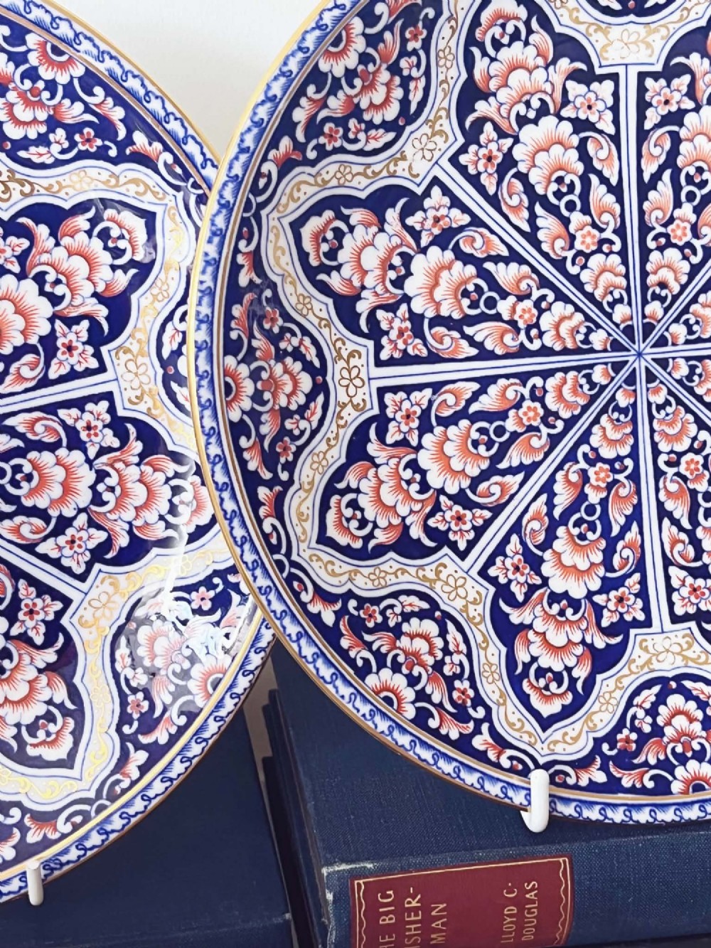 A seven-piece porcelain dessert service featuring intricate cobalt blue, terracotta, and gold geometric star patterns, comprising six plates and a comport. View VII