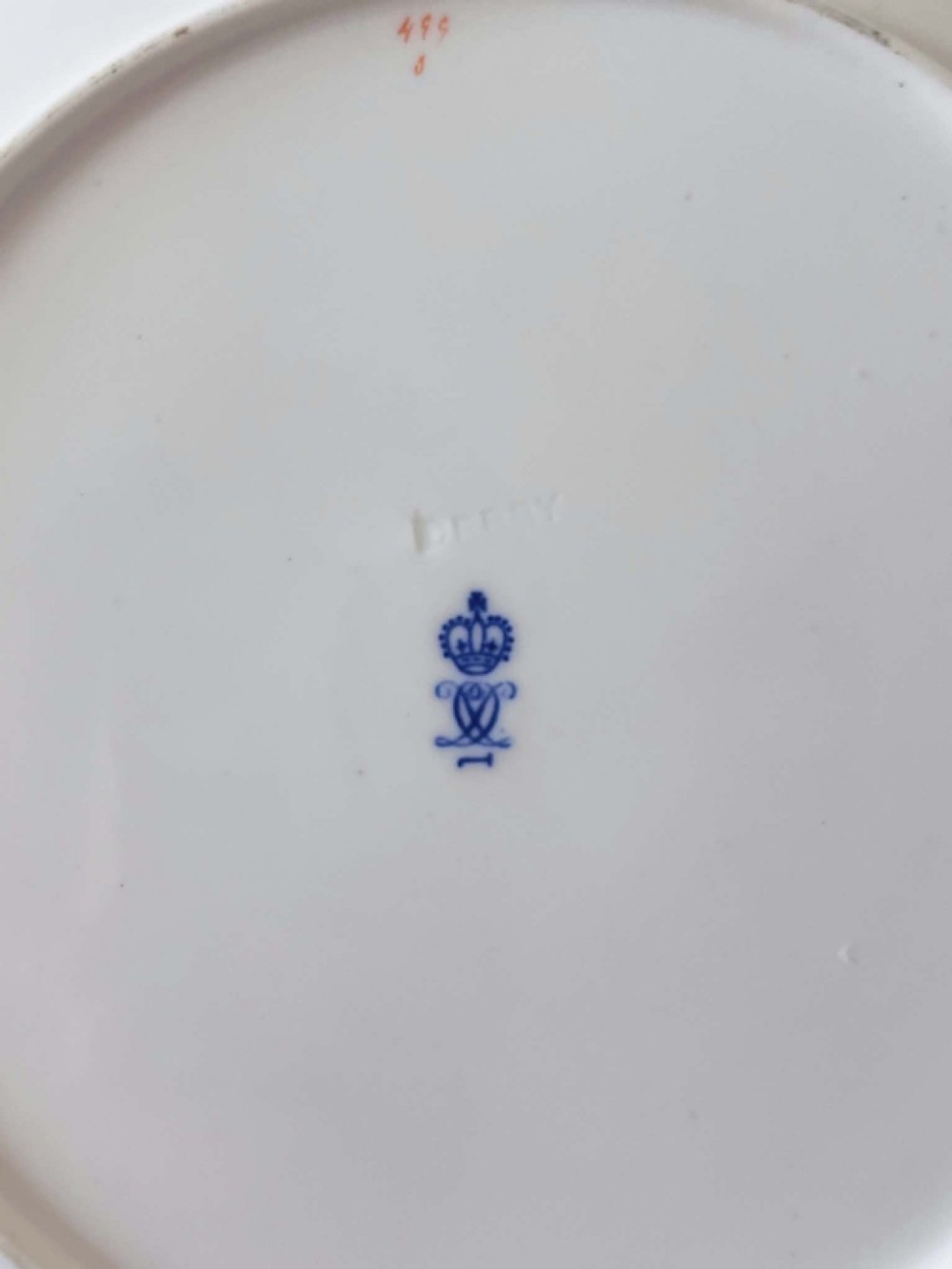 A seven-piece porcelain dessert service featuring intricate cobalt blue, terracotta, and gold geometric star patterns, comprising six plates and a comport. View XI