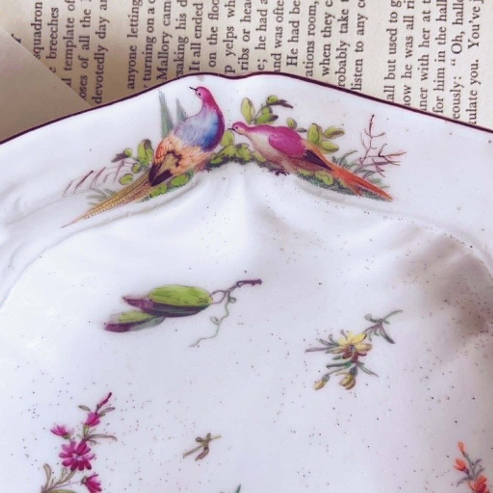 A white soft-paste porcelain moulded dish featuring hand-painted polychrome birds along the scalloped rim and floral sprigs in the centre. View II
