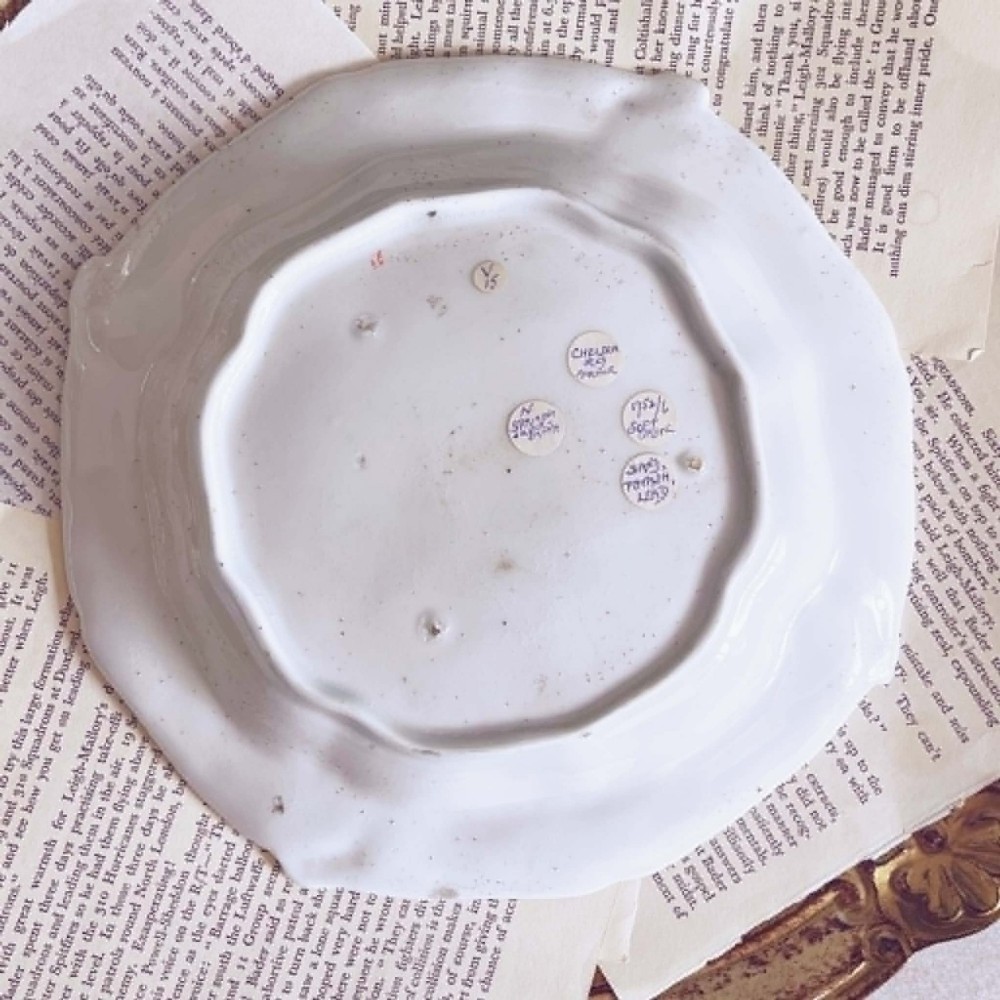A white soft-paste porcelain moulded dish featuring hand-painted polychrome birds along the scalloped rim and floral sprigs in the centre. View XIV
