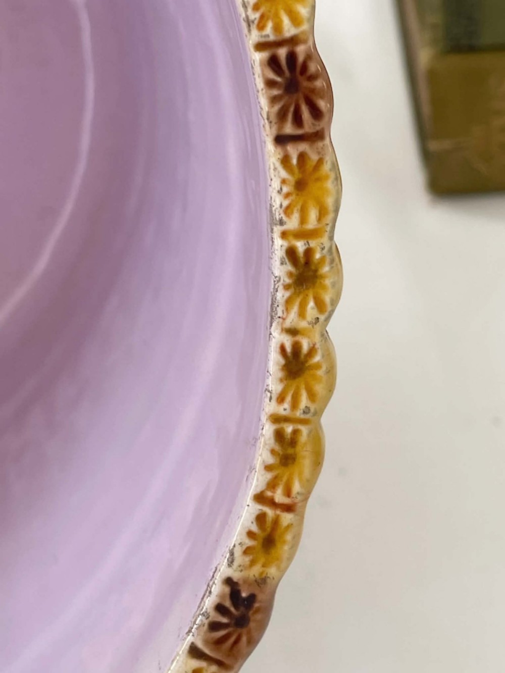 A cylindrical Victorian majolica jardiniere decorated with a moulded bamboo cane pattern in yellow and brown tones, wrapped with a blue ribbon tied in a bow. View XIV