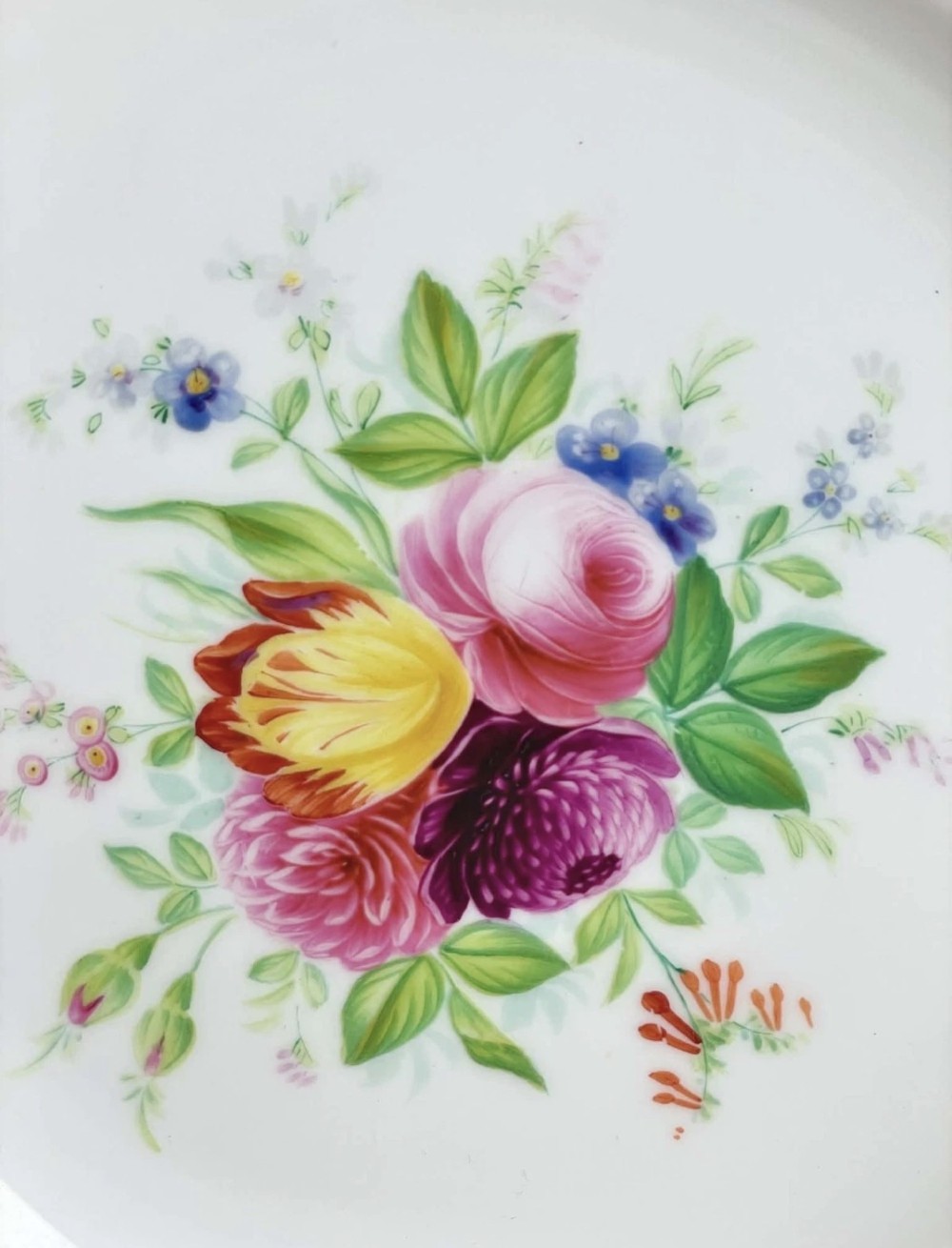 A circular porcelain dessert plate featuring a central hand-painted floral bouquet surrounded by a cobalt blue rim with gilded scrollwork. View VIII