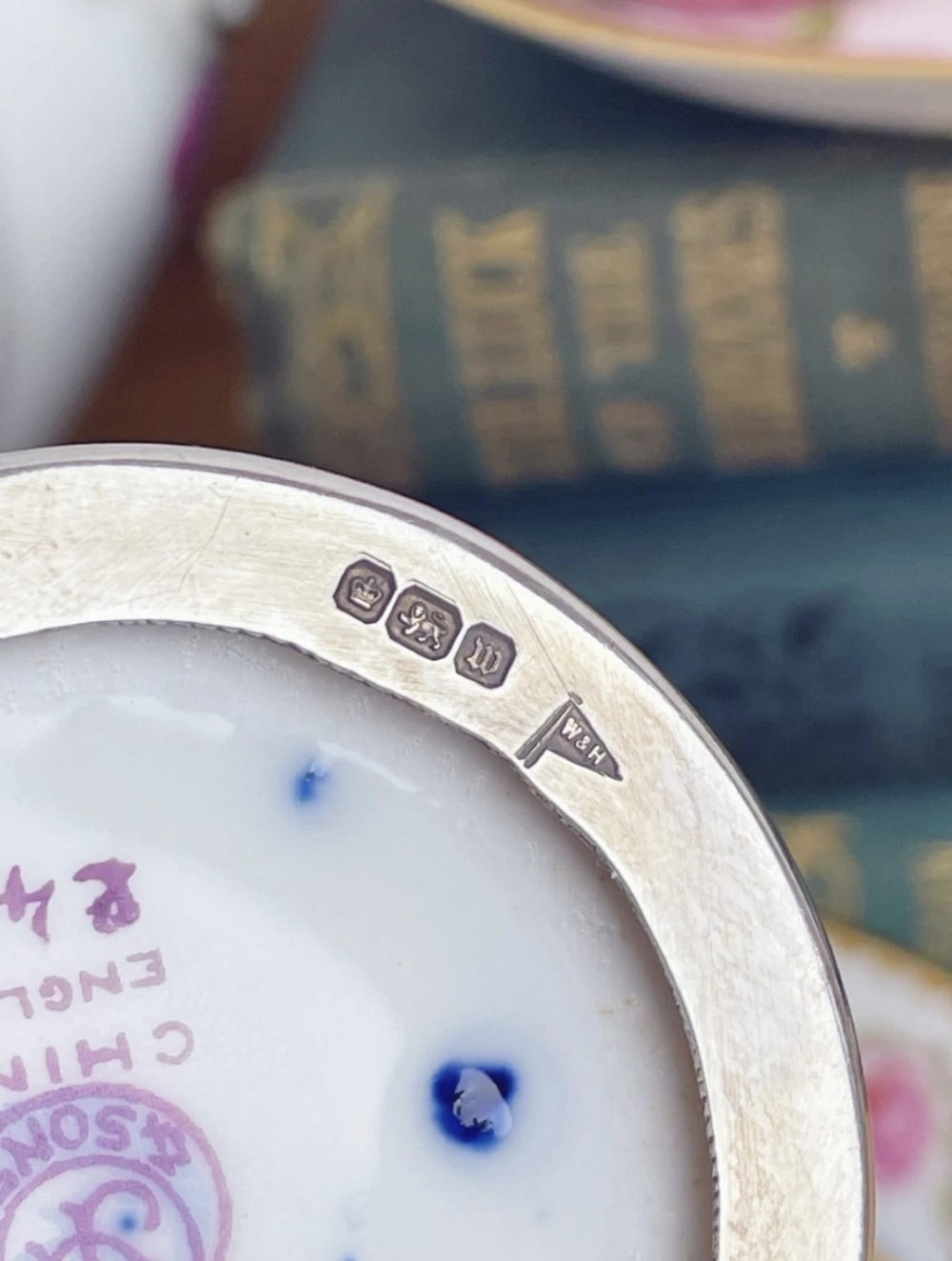 A cobalt blue porcelain coffee can decorated with pink floral swags, set inside a pierced sterling silver holder with a matching saucer. View VII