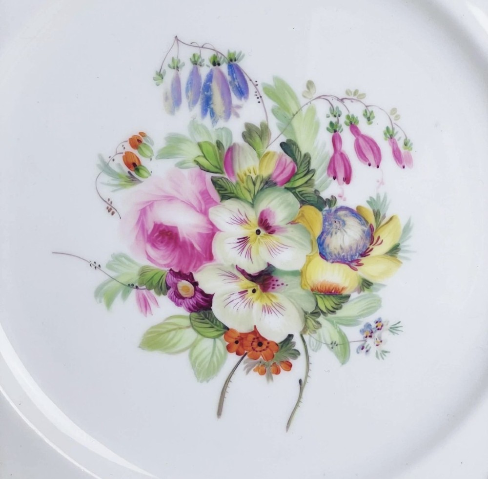 A circular Victorian Coalport porcelain dessert plate featuring a hand-painted central floral motif surrounded by an intricate gilded border. View VIII