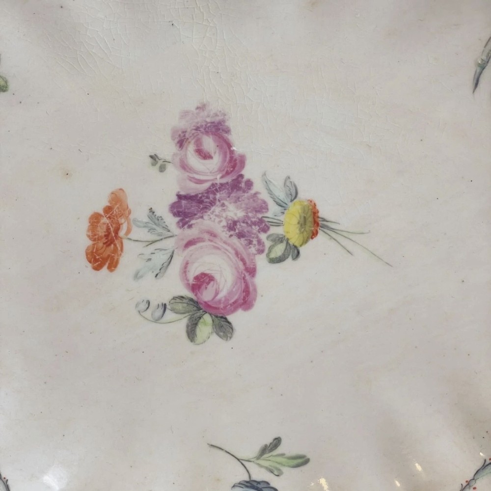 An eighteenth-century oval Derby porcelain serving dish with a scalloped rim, pink scroll border with gilt detailing, and central hand-painted floral spray. View VIII